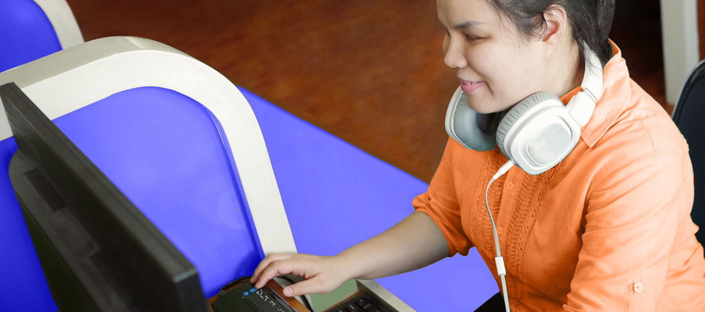 Woman using screen reader at computer.